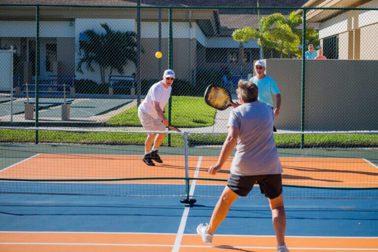 People playing pickleball at Camelot Lakes pickleball court.