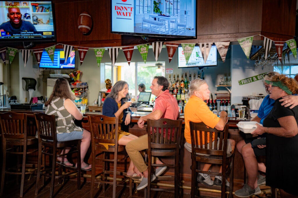 Couple grabbing a drink at Big Cypress Grill at the Big Cypress Golf Club in Lakeland, Florida.