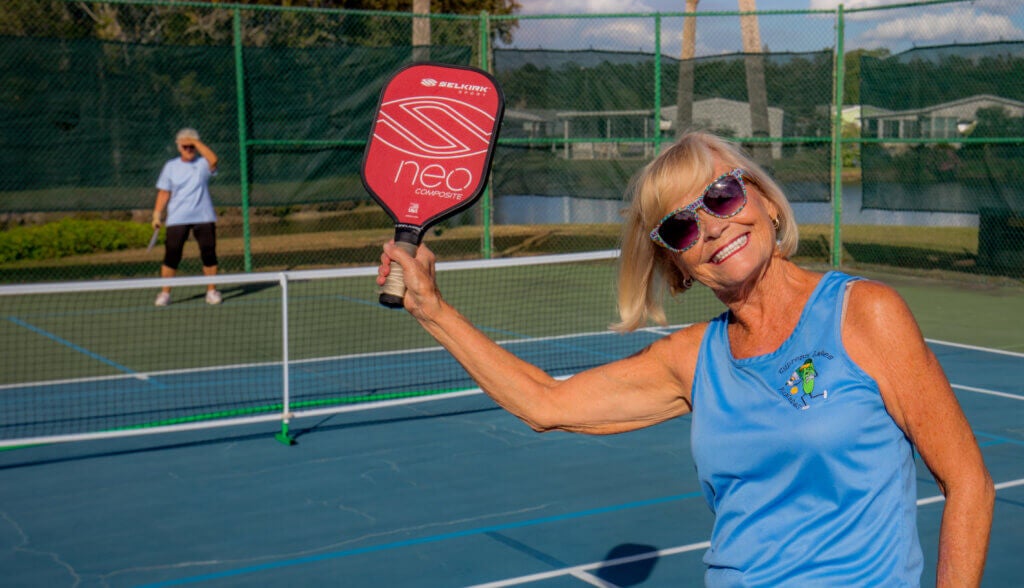 Resident at Cypress Lakes Village in Lakeland, FL. playing pickleball.