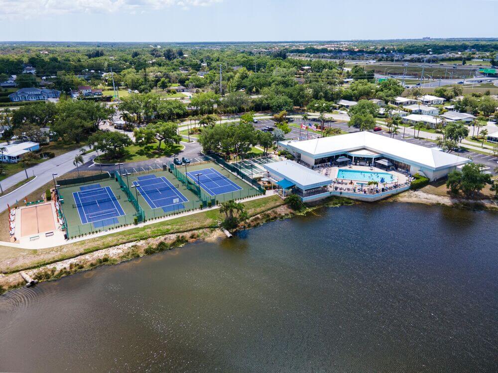Sports courts and swimming pool view of Camelot East Village in Sarasota, Florida.