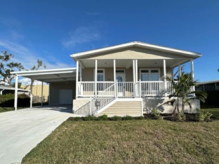 The exterior of a new manufactured home for sale in Sarasota, Florida in Camelot Lakes Village.
