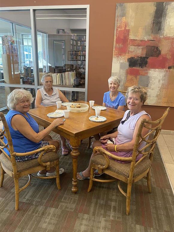 Four ladies drinking coffee around a table at Rolling Greens Village in Ocala, Florida.
