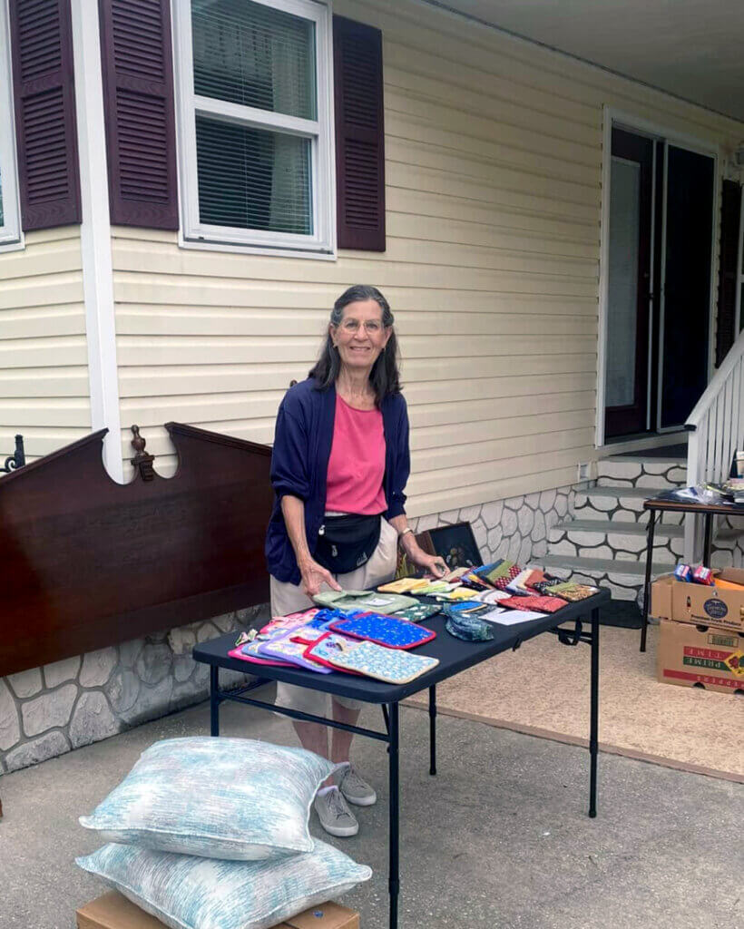 Resident at Rolling Greens Village in Ocala, Florida hosting a yard sale in the 55+ community.