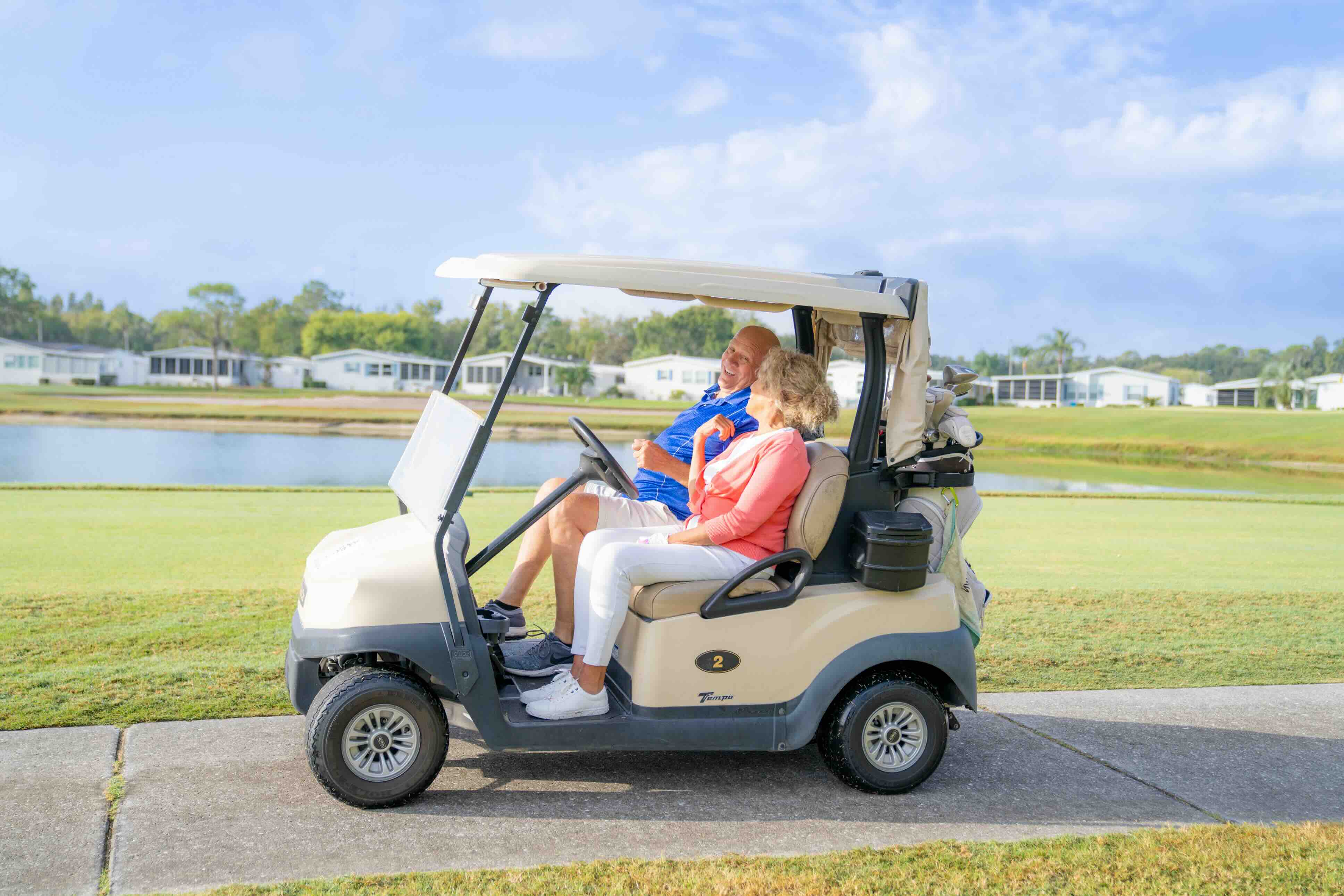 couple in golf cart on course