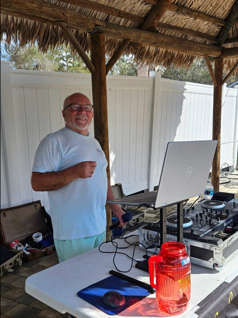 DJ Warzy plays music poolside for Holiday RV Guests