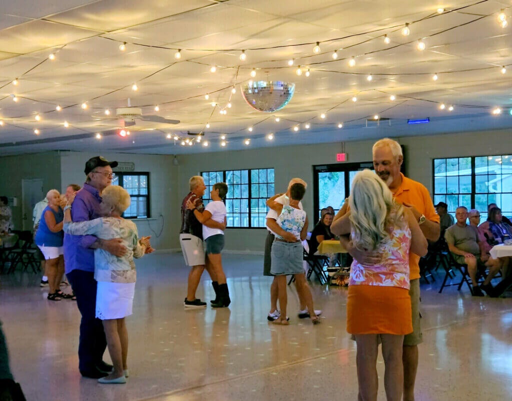 Residents dancing at community lifestyle event at Holiday RV Park