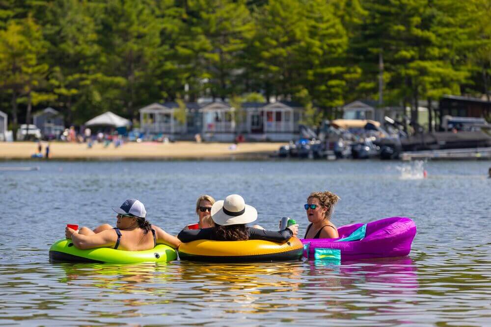 Women floating in tubes at Point Sebago Resort in Maine on Sebago Lake.