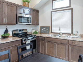 Inside the kitchen of an Elevation park model cabin at Sebago Lake at Point Sebago Resort in Maine.