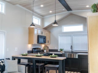 Elevation park model lake cabin showing a living room. These cabins are available for custom orders at Point Sebago Resort in Maine.