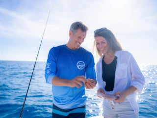 Couple Fishing Hook Big Pine Key Couple fishing on boat in the Florida Keys ocean.