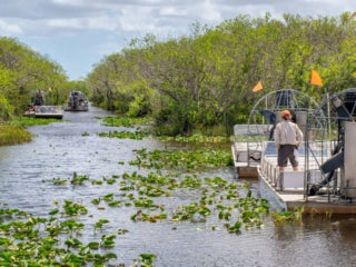 People on boat fishing in the Everglades.
