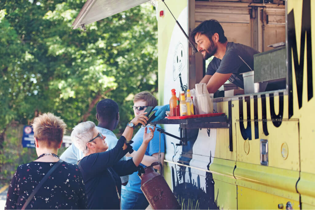 Seniors getting food from man in a food truck