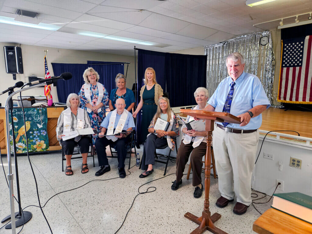 Members of the Holiday RV Park Choir are gathered in the activity center.