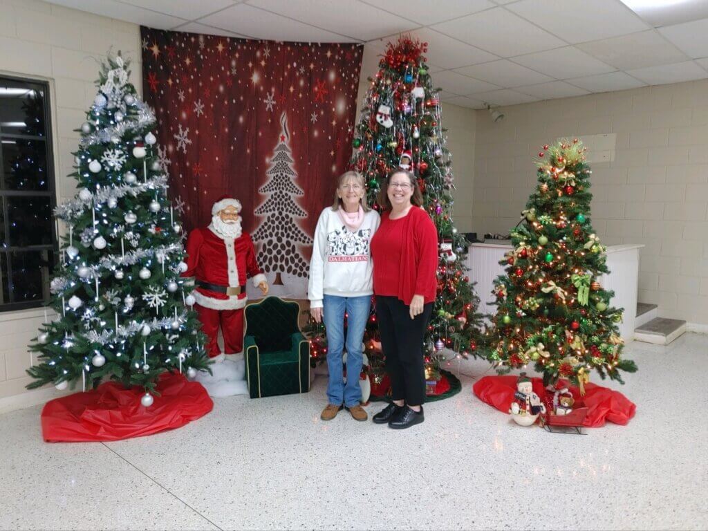 Guests on the Christmas Decorations Committee with their decorations at Holiday RV Park in Leesburg.