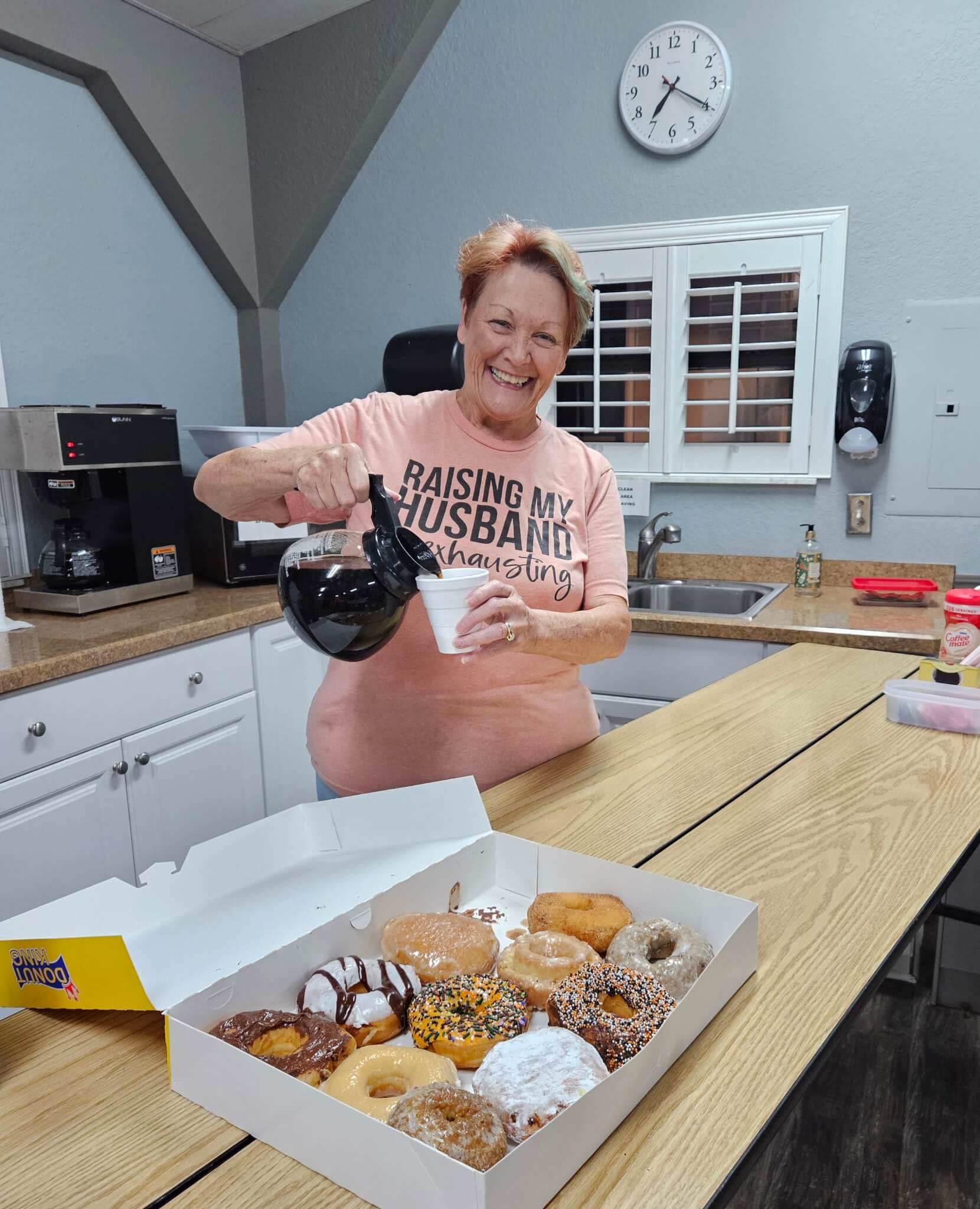 Guest with donuts pouring coffee into a cup