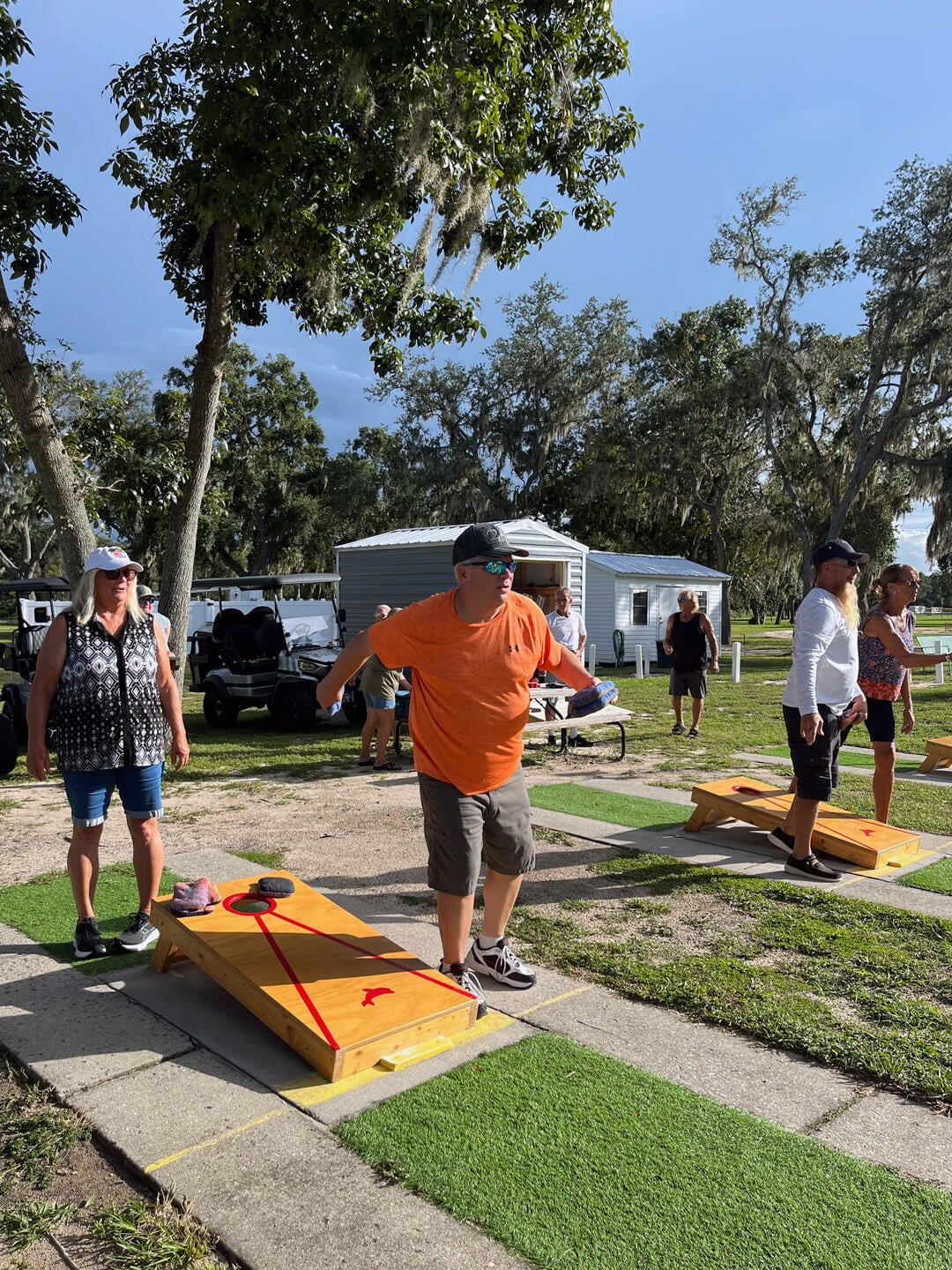 guests throwing bags playing cornhole