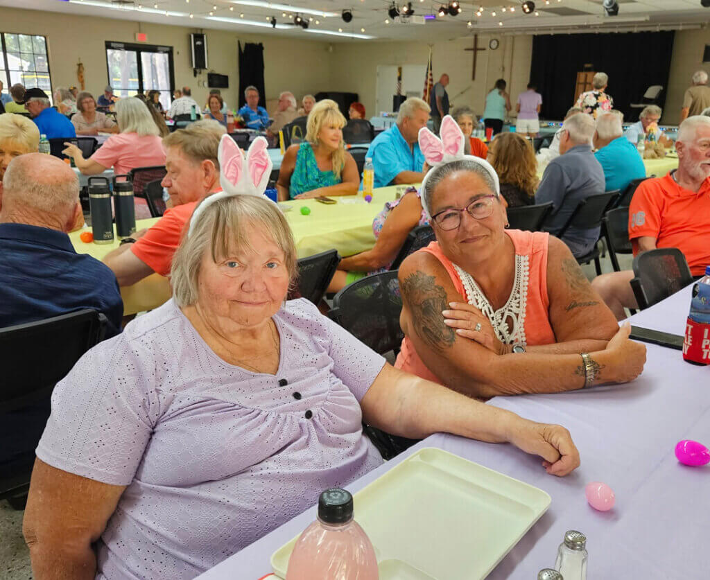 Guests at 55+ Holiday RV Park in Leesburg, FL wearing bunny ears at the Easter Potluck.