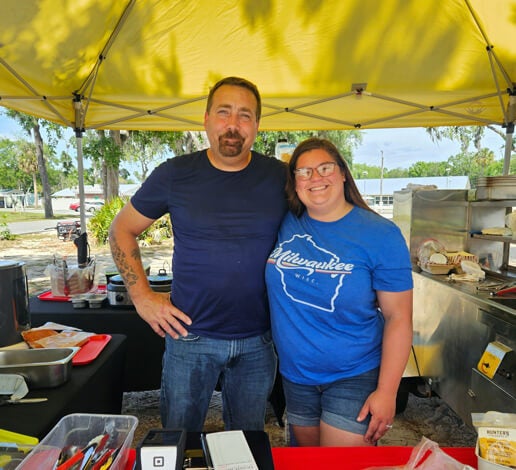 Midwest Sausage and Cheese food truck pop up tent is preparing food for 55+ residents at Holiday RV Park in Leesburg, Fl.