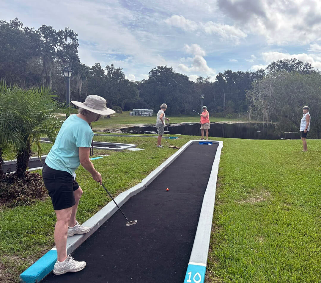 Guests at Holiday putting on the mini golf course