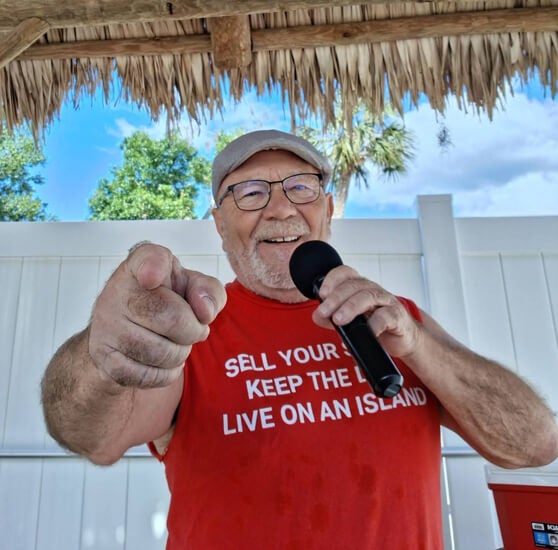 DJ Warzy plays music poolside for guests at Holiday RV Park in Leesburg, Fl