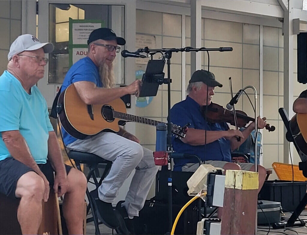 Guests from Holiday RV Park have a jam session at the outdoor stage in the Leesburg, FL RV Park