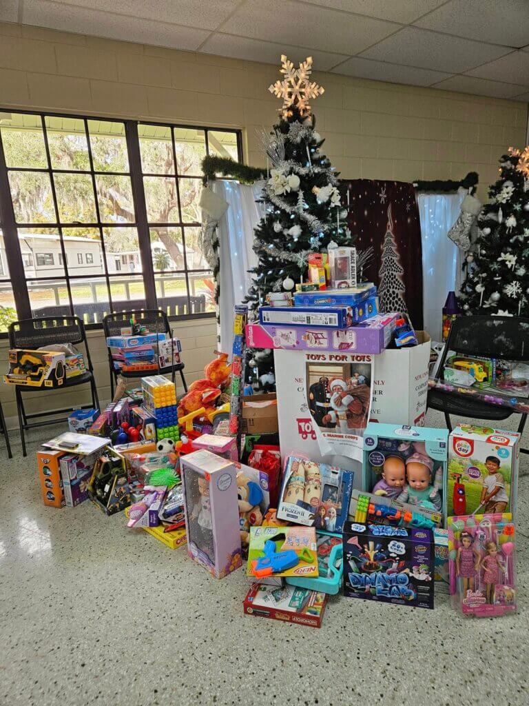 Present donations benefitting Toys for Tots, surrounding the Christmas tree at Holiday RV Park in Leesburg Florida.