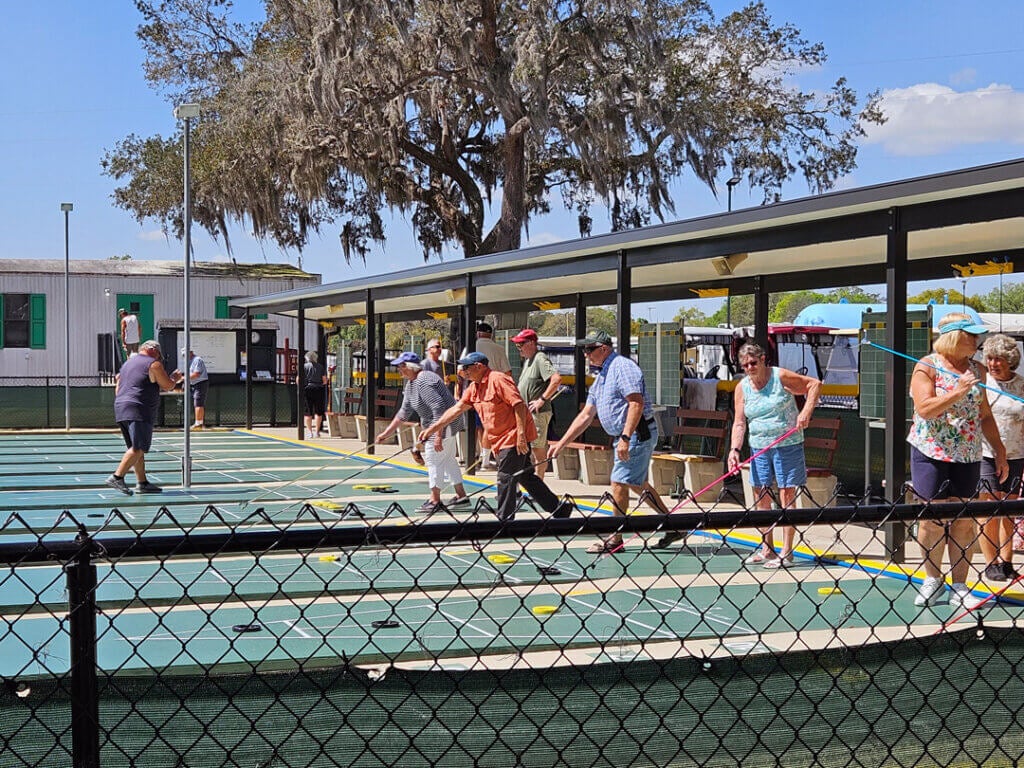 Guests playing shuffleboard at the Holiday RV sport courts