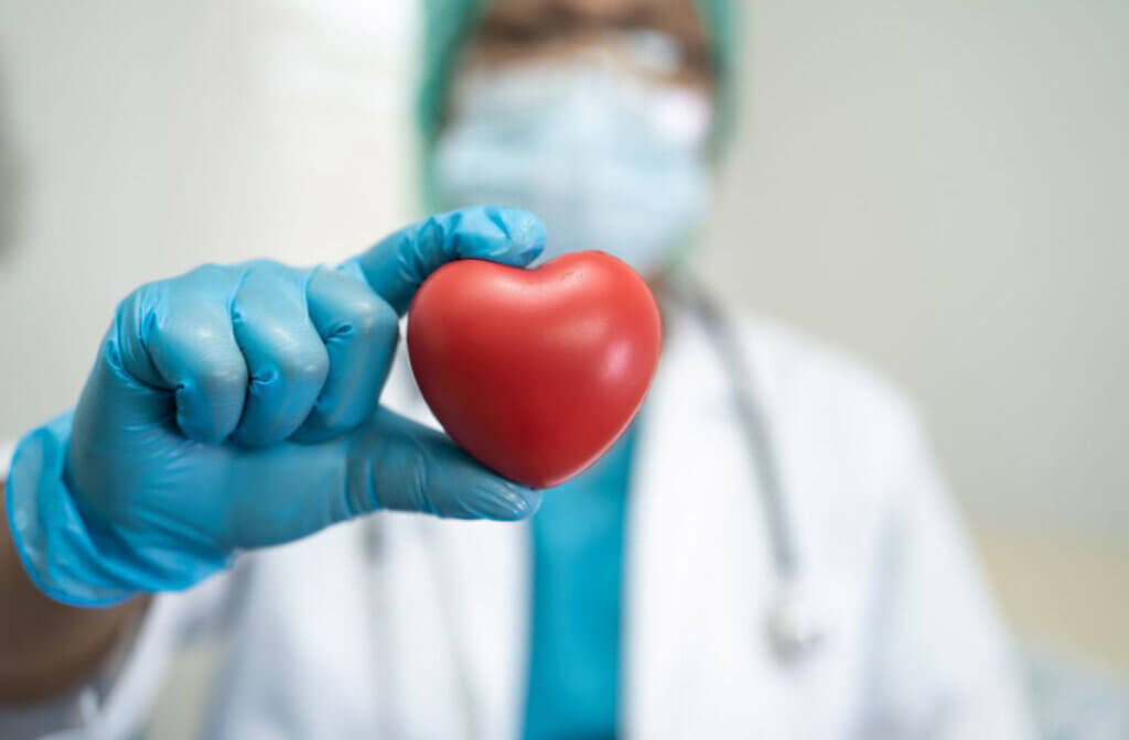 Health professional holding red heart