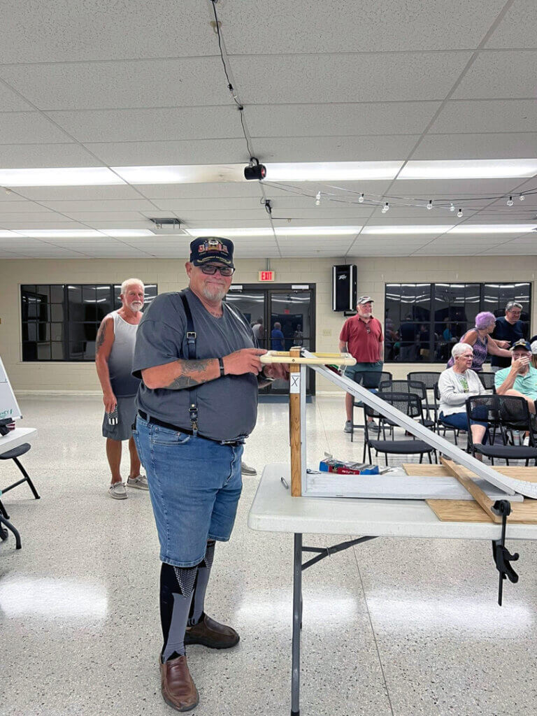Guest at Holiday RV Park attending the Hot Wheels Racing night standing with his car at the racing track.