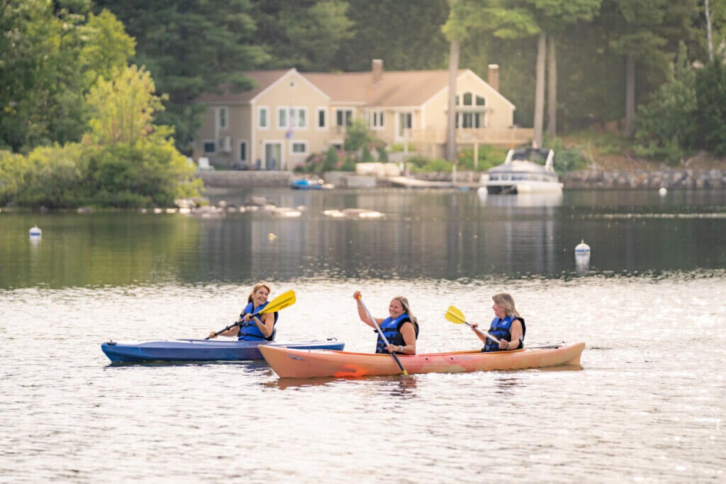 Lynne Harris and friends kayaking along Sebago Lake in Maine.