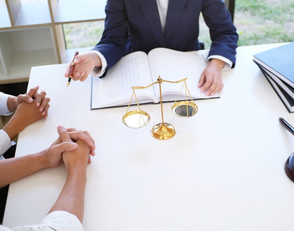 Lawyer with clients going over paperwork.