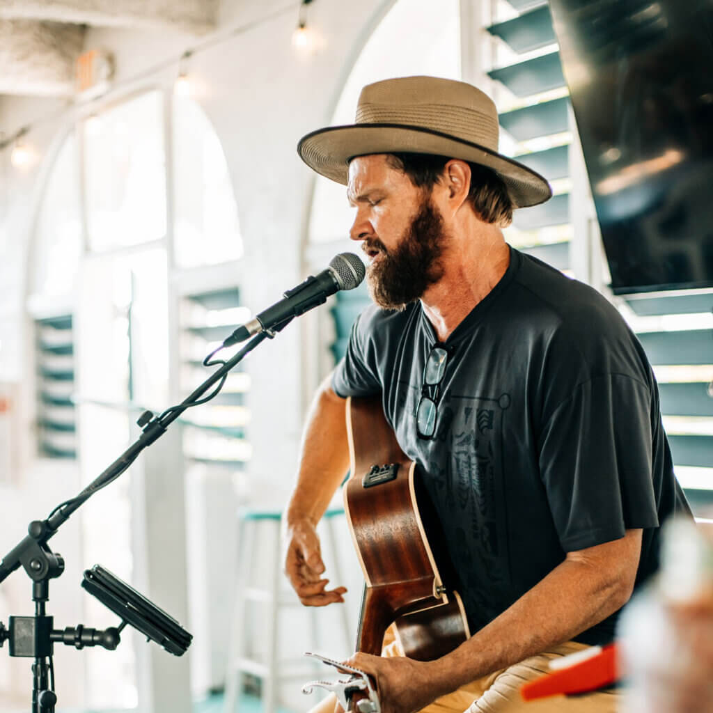 Man playing acoustic guitar at Big Pine Key Rv Park in Florida