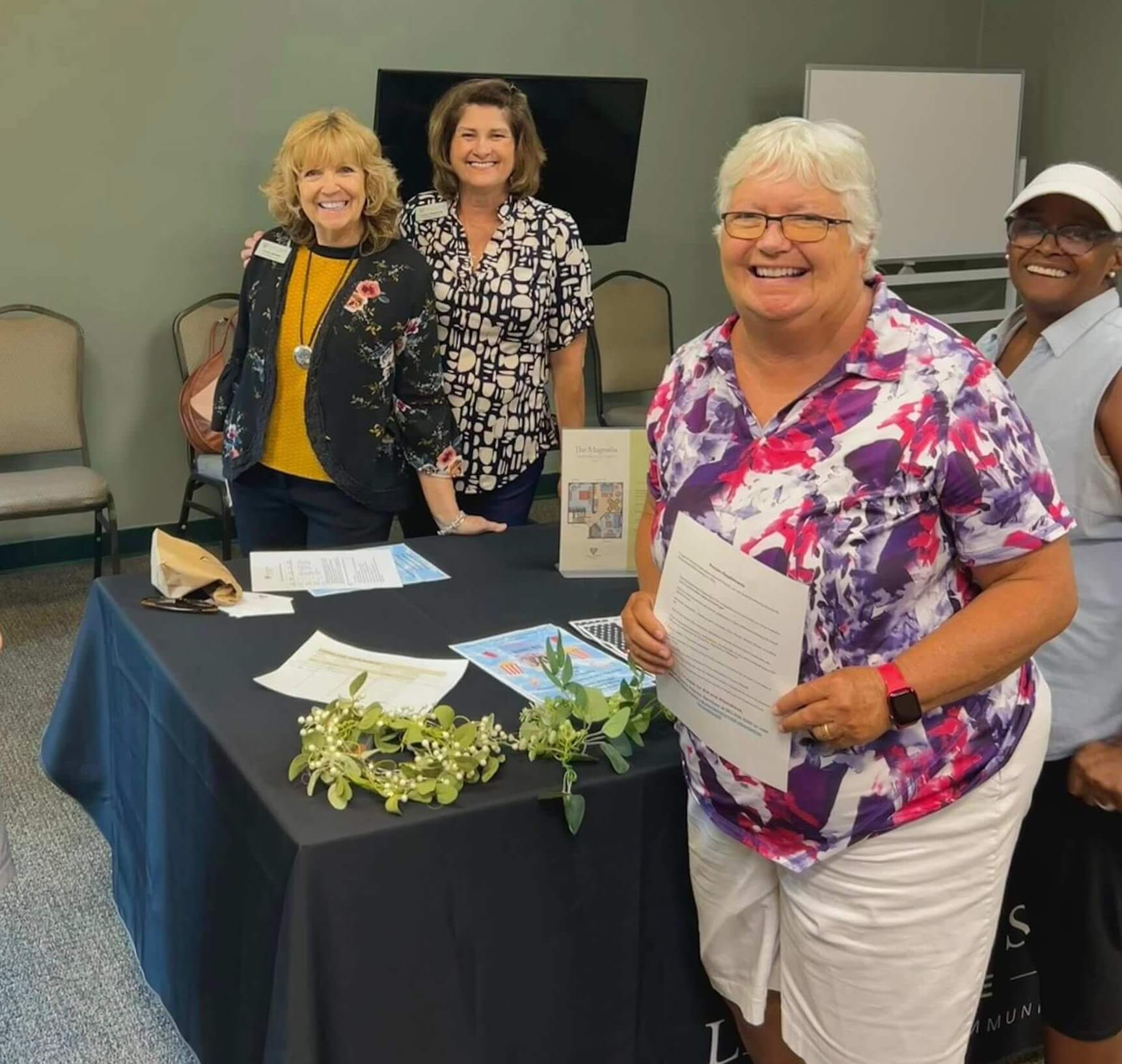 Residents attending a Lunch & Learn at Cypress Lakes Village in Lakeland, FL. The host is Cathy Stokes with Lake Gibson Village
