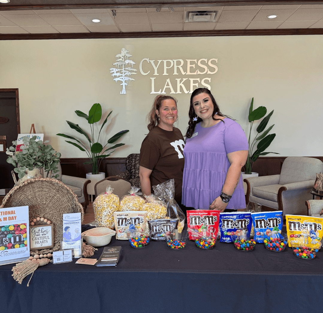 Bailey James from MIND & MOBILITY and Vicki Russell from Family First Senior Solutions celebrating National M&M Day at Cypress Lakes Village in Lakeland, FL.