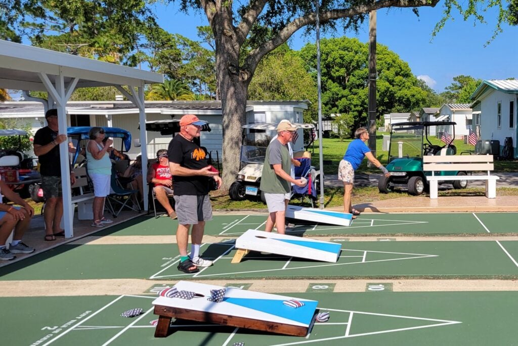 Residents playing corn hole at Meadowlea Village in central Florida.