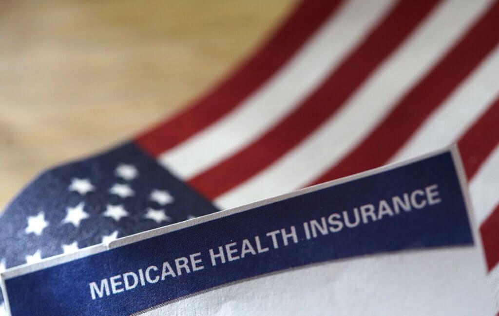 American flag and paper that says Medicare Health Insurance