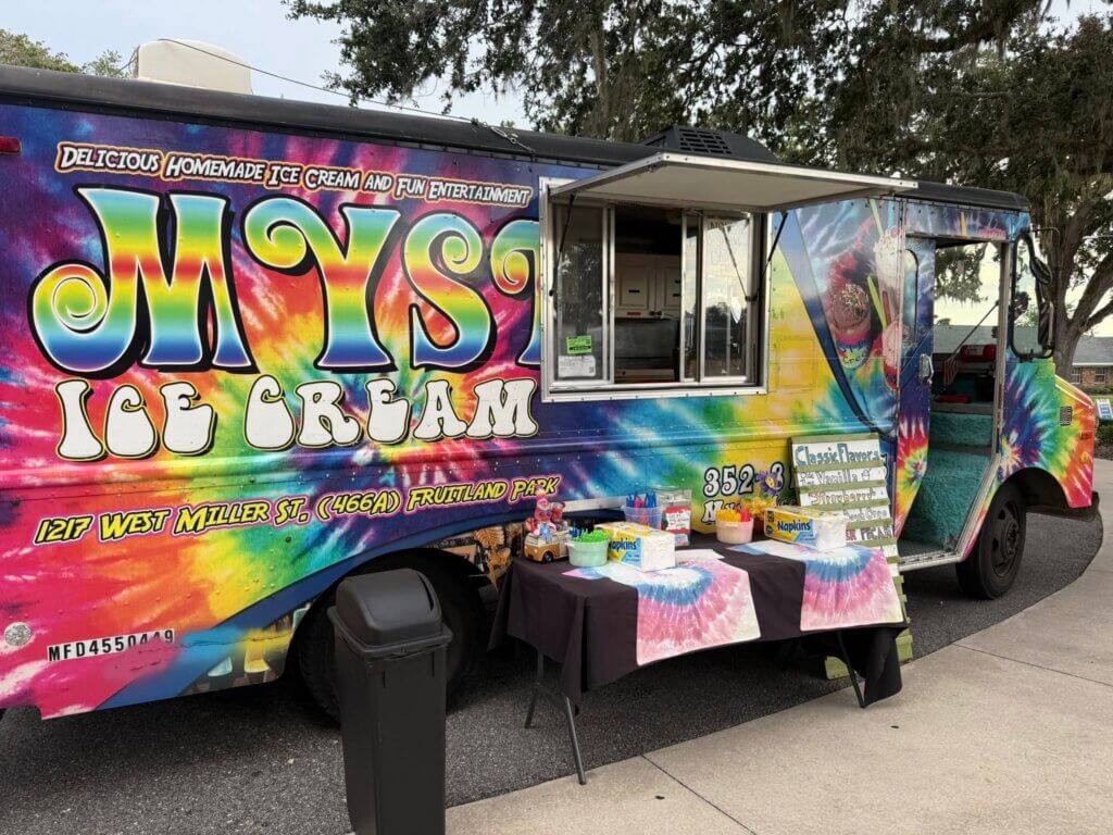 Mystic Ice Cream Tie Dye Food Truck set up in a parking lot at Holiday RV Park in Leesburg, FL.