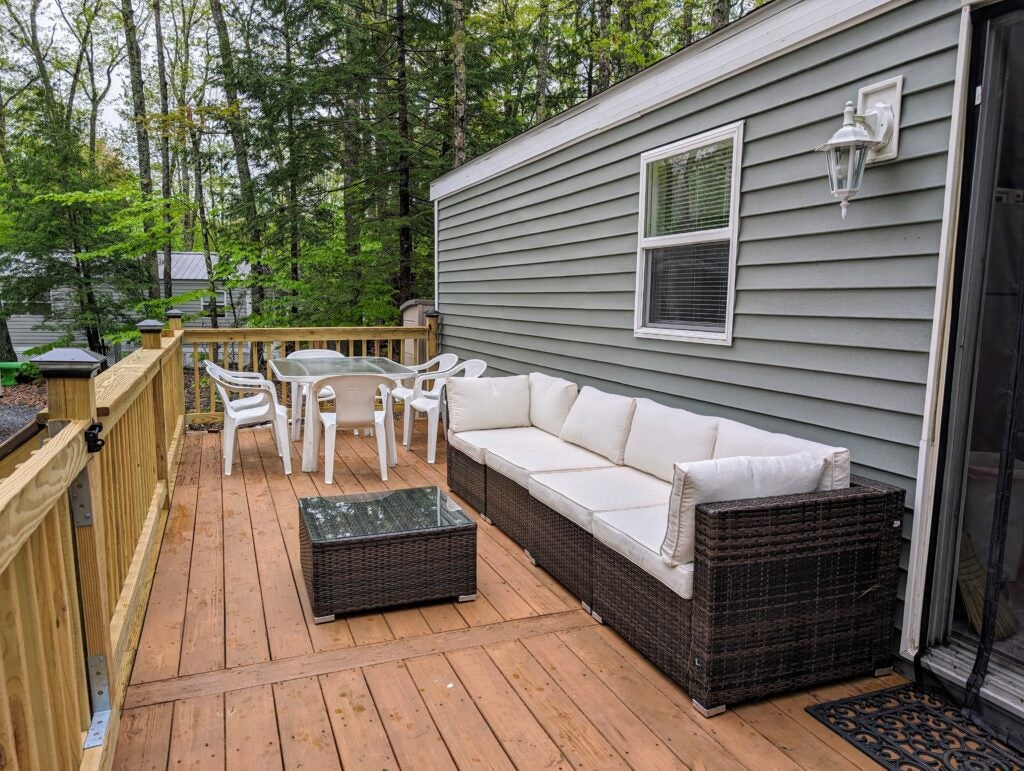 couch and table with chairs on a deck