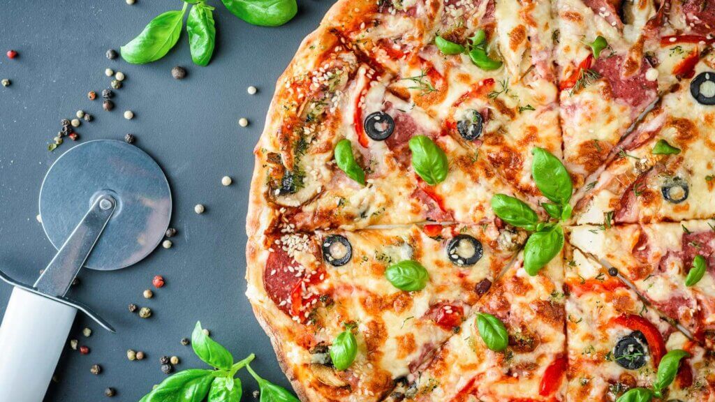 Italian pizza and pizza cutter by Lazy Bear from Getty Images Pro on Canva