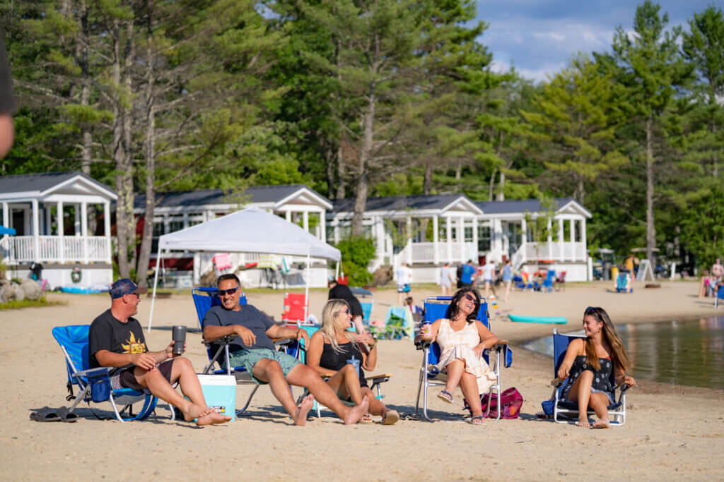 Friends hanging out on the beach at Point Sebago in Maine.