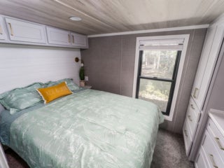 Bedroom inside the model cottage at Point Sebago. The photo shows an park model created by Elevation.