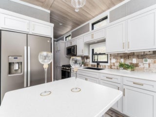 Kitchen inside the model cottage at Point Sebago. The photo shows an park model created by Elevation.