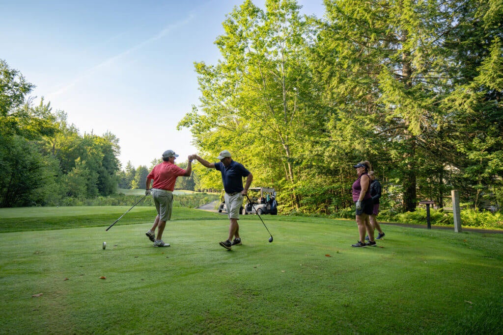 Golfers hanging out at the Point Sebago Golf Course in Maine.