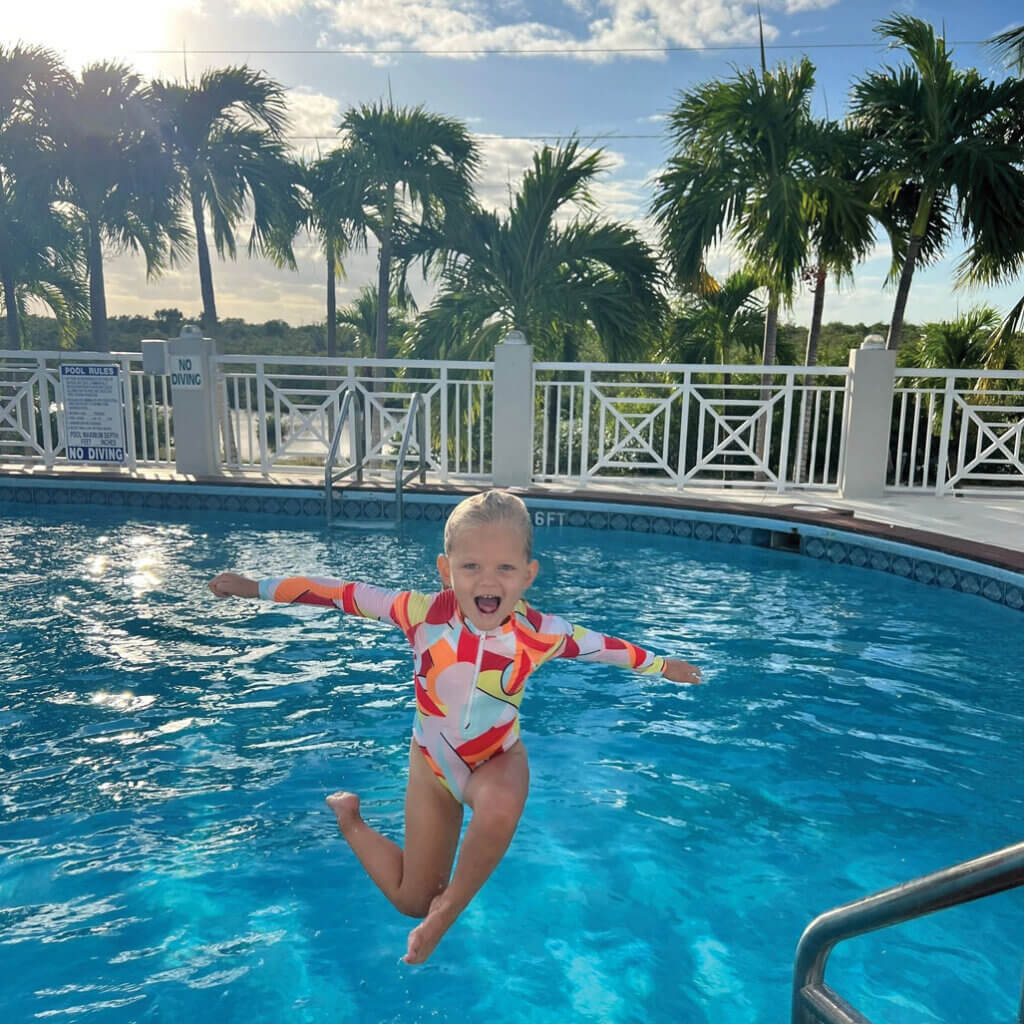 A little girl jumping into the rooftop swimming pool at Big Pine Key Rv Park in Florida