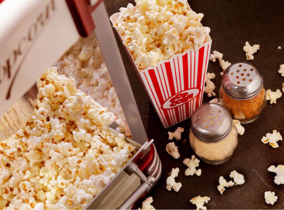 Popcorn machine and box of popcorn and toppings