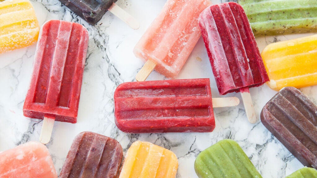 Homemade ice cream popsicles in varies colors by Picalotta from Getty Images on Canva