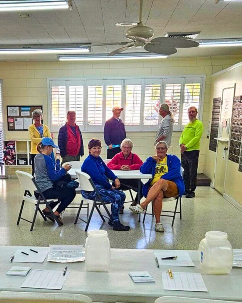 Guests are sitting in the community center at holiday RV Park in Leesburg, FL for a Resident Fund Committee meeting.