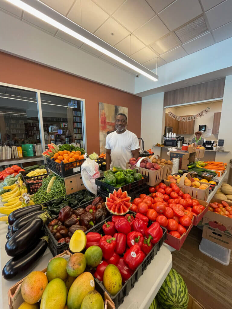 Resident with produce at the free grocery event held at Rolling Greens Village in Ocala, Florida.