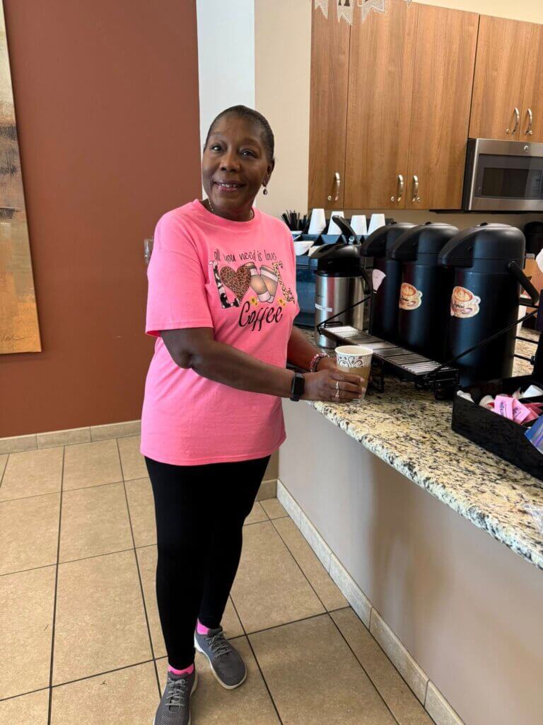 Resident at Rolling Greens Village in Ocala, Florida, at a free coffee-and-donut event in the community center.