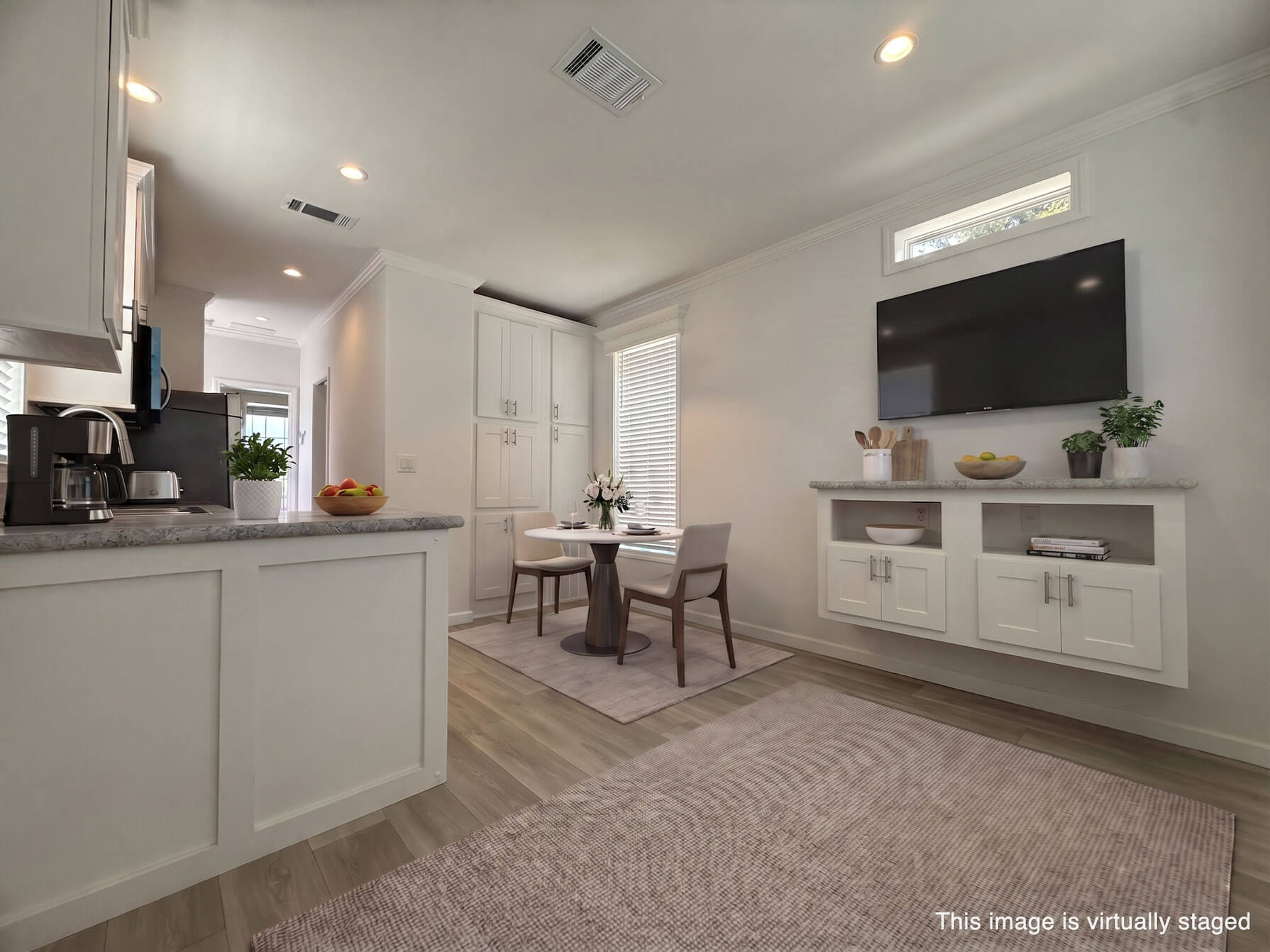 A virtually staged dining room and kitchen in a park model home for sale at River Vista RV Park in Ruskin, Florida.